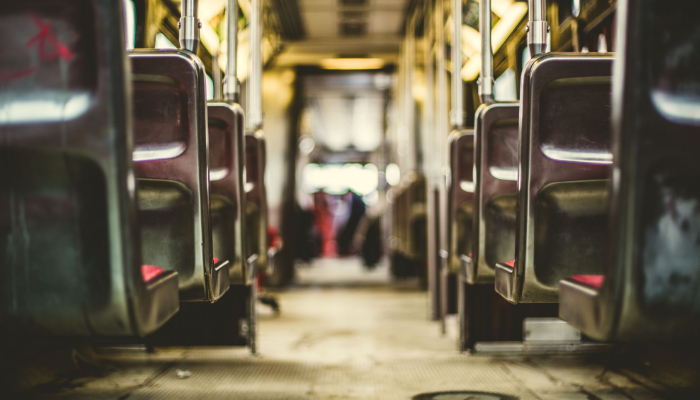 Hansaton: Looked down the center aisle of a bus from the back to the front.