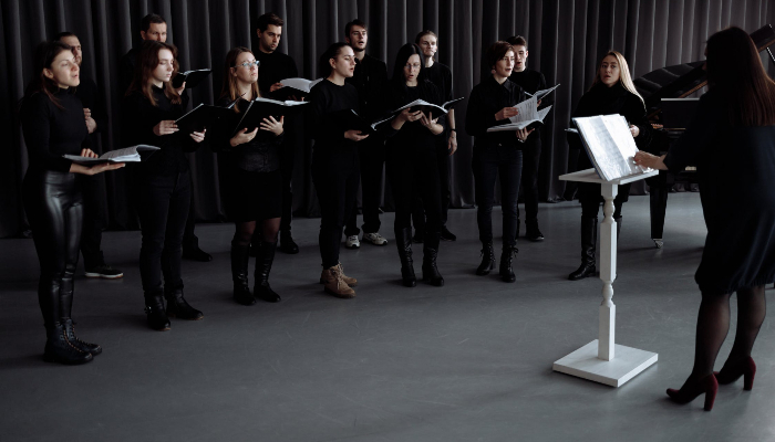 Audio Service: Black-clad choir and white conductor's podium