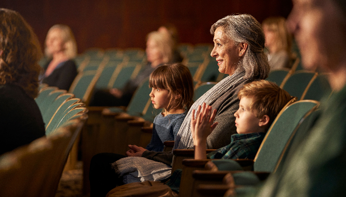 ReSound: Family is sitting in the auditorium and looking at the stage.