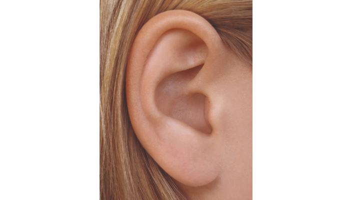 Widex: Women's ear with small hearing aid